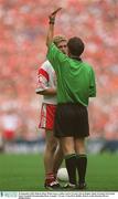 28 September 2003; Referee Brian White issues a yellow card to Tyrone's Kevin Hughes. Bank of Ireland All-Ireland Senior Football Championship Final, Armagh v Tyrone, Croke Park, Dublin. Picture credit; Brendan Moran / SPORTSFILE