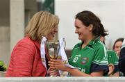 30 March 2019; Scoil Chríost Rí captain Erone Fitzpatrick is presented with the cup by Ladies Gaelic Football Association President Marie Hickey after the Lidl All-Ireland Post-Primary Schools Senior A Final match between Loreto, Clonmel, and Scoil Chríost Rí, Portlaoise, at John Locke Park in Callan, Co Kilkenny. Photo by Diarmuid Greene/Sportsfile