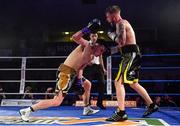 30 March 2019; Allan Phelan, right, knocksdown Aiden Metcalfe, resulting in a countout, during their vacant BUI Celtic Super Featherweight title bout at the National Stadium in Dublin. Photo by Seb Daly/Sportsfile