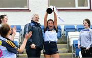 6 April 2019; Cashel Community School captain Leah Baskin lifts the cup in the company of  LGFA Munster branch president Jerome Casey after the Lidl All Ireland Post Primary School Junior C Final match between Cashel Community School and FCJ Bunclody at St Molleran’s in Carrickbeg, Co. Waterford. Photo by Diarmuid Greene/Sportsfile
