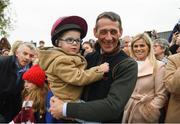 7 April 2019; Jockey Davy Russell, with his son Finn, as the winner of the 2019 Randox Health Aintree Grand National Tiger Roll is led through the village of Summerhill in County Meath. Photo by Harry Murphy/Sportsfile