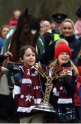 7 April 2019; Zack, left, and Tiana O'Leary, children of owner Michael O'Leary with the cup as the winner of the 2019 Randox Health Aintree Grand National Tiger Roll is led through the village of Summerhill in County Meath by grooms Karen Morgan, left, and Louise Dunne. Photo by Harry Murphy/Sportsfile