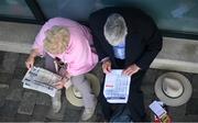 22 April 2019; Racegoers study the form prior to racing at Fairyhouse Easter Festival - Irish Grand National day at Fairyhouse Racecourse in Ratoath, Meath. Photo by David Fitzgerald/Sportsfile