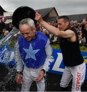 1 May 2019; Ruby Walsh is soaked by fellow jockey Davy Russell after he announced his retirement after he rode Kemboy to win The Coral Punchestown Gold Cup during the Punchestown Festival Gold Cup Day at Punchestown Racecourse in Naas, Kildare. Photo by David Fitzgerald/Sportsfile
