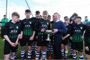 11 May 2019; Chairman of the SFAI John Early presents the cup to Harry Lloyd of Hanover Harps following the U15 SFAI Cup Final 2019 match between Stella Maris and Hanover Harps at Oscar Traynor Centre in Dublin. Photo by Michael P. Ryan/Sportsfile