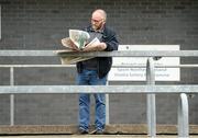 12 May 2019; A general view of a supporter on the terrace flicking through the newspaper before the Ulster GAA Football Senior Championship preliminary round match between Tyrone and Derry at Healy Park, Omagh in Tyrone. Photo by Oliver McVeigh/Sportsfile