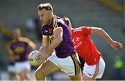12 May 2019; Jonathan Bealin of Wexford in action against Emmet Carolan of Louth during the Leinster GAA Football Senior Championship Round 1 match between Wexford and Louth at Innovate Wexford Park in Wexford.   Photo by Matt Browne/Sportsfile