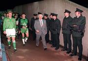 17 November 1993; Northern Ireland captain Alan McDonald and Republic of Ireland captain Andy Townsend lead their teams onto the field, watched by the RUC, during the FIFA World Cup Qualifier match between Northern Ireland and Republic of Ireland at Windsor Park in Belfast. Photo by Ray McManus/Sportsfile