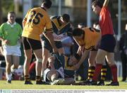 21 October 2003; Referee Brian White indicates a free as an injured Declan Browne is 'assisted' by Western Australia's Ashley Prescott (25). Foster's International Rules, Preparation match, Western Australia v Ireland, Swan Districts Football Club, Bassendean Oval, Bassendean, Perth, Western Australia. Picture credit; Ray McManus / SPORTSFILE *EDI*