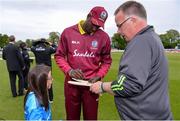 15 May 2019; Jason Holder of West Indies signs an autograph for mascot Christina Troup, aged 6, ahead of the One-Day International Tri-Series Final match between West Indies and Bangladesh at Malahide Cricket Ground, Malahide, Dublin. Photo by Sam Barnes/Sportsfile