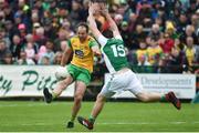 26 May 2019; Michael Murphy of Donegal scoring a point despite the attempted block of Sean Quigley of Fermanagh during the Ulster GAA Football Senior Championship Quarter-Final match between Fermanagh and Donegal at Brewster Park in Enniskillen, Fermanagh. Photo by Oliver McVeigh/Sportsfile