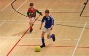 26 May 2019; Jamie Dorr of Clonguish, Co Longford, front, in action against Danny Downey of Inniskeen, Co Monaghan, in the Indoor Soccer U13 Boys Semi-Final during Day 2 of the Aldi Community Games May Festival, which saw over 3,500 children take part in a fun-filled weekend at University of Limerick. Photo by Piaras Ó Mídheach/Sportsfile