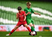 29 May 2019; The SPAR FAI Primary School 5s National Finals took place in AVIVA Stadium on Wednesday, May 29, where former Republic of Ireland International Keith Andrews and current Republic of Ireland women's footballer, Megan Campbell were in attendance supporting as girls and boys from 13 counties battled it out for national honours. The 2019 SPAR FAI Primary School 5s Programme was the biggest yet with a record 37,448 participants from 1,696 schools taking part in county, regional and provincial blitzes nationwide. Pictured is Liam Murphy of St. John the Apostle NS, Knocknacarra, Co. Galway, in action against Scoil Phádraig Naofa from Rochestown, Co. Cork, at the Aviva Stadium in Dublin. Photo by Harry Murphy/Sportsfile