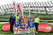 29 May 2019; The SPAR FAI Primary School 5s National Finals took place in AVIVA Stadium on Wednesday, May 29, where former Republic of Ireland International Keith Andrews and current Republic of Ireland women's footballer, Megan Campbell were in attendance supporting as girls and boys from 13 counties battled it out for national honours. The 2019 SPAR FAI Primary School 5s Programme was the biggest yet with a record 37,448 participants from 1,696 schools taking part in county, regional and provincial blitzes nationwide. Pictured is the St Laurence National School team, from Buncrana, Co. Donegal, with David Bagnall, Spar, left, after winning the Girls Section C tournament at the Aviva Stadium in Dublin. Photo by Sam Barnes/Sportsfile
