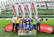 29 May 2019; The SPAR FAI Primary School 5s National Finals took place in AVIVA Stadium on Wednesday, May 29, where former Republic of Ireland International Keith Andrews and current Republic of Ireland women's footballer, Megan Campbell were in attendance supporting as girls and boys from 13 counties battled it out for national honours. The 2019 SPAR FAI Primary School 5s Programme was the biggest yet with a record 37,448 participants from 1,696 schools taking part in county, regional and provincial blitzes nationwide. Pictured are players and coaches from Mucklagh NS, Co Offaly with Spar Representatives Carl and Colm McDaid. Photo by David Fitzgerald/Sportsfile