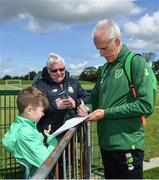 3 June 2019; Republic of Ireland manager Mick McCarthy signs an autograph for Lorcan Cronin, age 8, from Rathcoole, Co Dublin during a meet and greet at FAI National Training Centre in Abbotstown, Dublin. Photo by David Fitzgerald/Sportsfile
