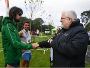 15 June 2019; Chair of Competitions John Cronin presents Michael Clohisey of Raheny Shamrock A.C., Co. Dublin, with his winners medal following the Irish Runner 5 Mile in conjunction with the AAI National 5 Mile Championships at the Phoenix Park in Dublin. Photo by Harry Murphy/Sportsfile