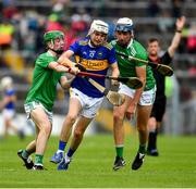 16 June 2019; Colm Fogarty of Tipperary in action against Adam Murrihy, left, and Ethan Hurley of Limerick  during the Electric Ireland Munster GAA Minor Hurling Championship Round 5 match between Tipperary and Limerick in Semple Stadium, Thurles, in Tipperary. Photo by Ray McManus/Sportsfile