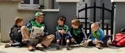 16 June 2019;  Ben Egan, 6, Mike Carroll, Ted Egan, 9, David Magner, 9, and Jack Egan, 8, all from Effin, relax with a newspaper before the Munster GAA Hurling Senior Championship Round 5 match between Tipperary and Limerick in Semple Stadium in Thurles, Tipperary. Photo by Ray McManus/Sportsfile