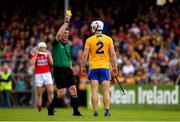16 June 2019; Referee Paud O'Dwyer shows a yellow card to Patrick O'Connor of Clare  during the Munster GAA Hurling Senior Championship Round 5 match between Clare and Cork at Cusack Park in Ennis, Clare. Photo by Eóin Noonan/Sportsfile