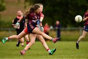 22 June 2019; Tegan Foley of Westmeath kicks a point under pressure from Kate Harkin of Derry during the Ladies Football All-Ireland U14 Bronze Final 2019 match between Derry and Westmeath at St Aidan's GAA Club in Templeport, Cavan. Photo by Ray McManus/Sportsfile