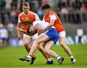 22 June 2019; Fintan Kelly of Monaghan is tackled by Aidan Nugent, right, and Rian O'Neill of Armagh during the GAA Football All-Ireland Senior Championship Round 2 match between Monaghan and Armagh at St Tiarnach's Park in Clones, Monaghan. Photo by Ray McManus/Sportsfile