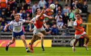 22 June 2019; Jarlath Óg Burns, supported by Jemar Hall of Armagh, right, in action against Monaghan players Ryan McAnespie, left, and Karl O'Connell during the GAA Football All-Ireland Senior Championship Round 2 match between Monaghan and Armagh at St Tiarnach's Park in Clones, Monaghan.  Photo by Ray McManus/Sportsfile