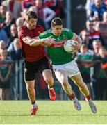 22 June 2019; Lee Keegan of Mayo in action against Conor Poland of Down during the GAA Football All-Ireland Senior Championship Round 2 match between Down and Mayo at Pairc Esler in Newry, Down.  Photo by Oliver McVeigh/Sportsfile