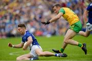 23 June 2019;Thomas Galligan of Cavan of Cavan in action against Neil McGee of Donegal  during the Ulster GAA Football Senior Championship Final match between Donegal and Cavan at St Tiernach's Park in Clones, Monaghan. Photo by Oliver McVeigh/Sportsfile