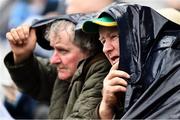 23 June 2019; Meath supporters Matt Grimes, from Dundalk, Co Louth and Noel Clarke, right, from Simonstown GAA Club, Co Meath, take shelter during the Leinster GAA Football Senior Championship Final match between Dublin and Meath at Croke Park in Dublin. Photo by Ray McManus/Sportsfile