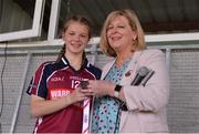 22 June 2019; Galway captain Brenda Naughton is presented with the Runners-up medal by LGFA President Marie Hickey following the Ladies Football All-Ireland U14 Platinum Final 2019 match between Cork and Galway at St Rynaghs in Banagher, Offaly. Photo by Ben McShane/Sportsfile