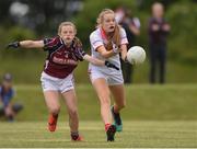 22 June 2019; Tara Hickey of Cork in action against Róisín Reddington of Galway during the Ladies Football All-Ireland U14 Platinum Final 2019 match between Cork and Galway at St Rynaghs in Banagher, Offaly. Photo by Ben McShane/Sportsfile