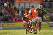 29 June 2019; Fionn McDonagh of Mayo kicks a point despite the attention of Jemar Hall, left, and Paul Hughes, 4, of Armagh during the GAA Football All-Ireland Senior Championship Round 3 match between Mayo and Armagh at Elverys MacHale Park in Castlebar, Mayo. Photo by Ben McShane/Sportsfile