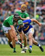 30 June 2019; John O'Dwyer of Tipperary is tackled by Gearoid Hegarty and Richie English of Limerick during the Munster GAA Hurling Senior Championship Final match between Limerick and Tipperary at LIT Gaelic Grounds in Limerick. Photo by Brendan Moran/Sportsfile