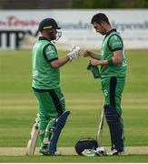 1 July 2019; Paul Stirling and Andrew Balbirnie of Ireland congratulate each other after reaching a 100 partnership during the Men’s Cricket 1st One Day International match between Ireland and Zimbabwe at Bready Cricket Club in Magheramason, Tyrone. Photo by Oliver McVeigh/Sportsfile