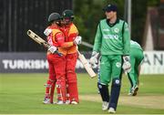 1 July 2019; Craig Ervine of Zimbabwe, right, celebrates with Ryan Burl after his 100th run during the Men’s Cricket 1st One Day International match between  Ireland and Zimbabwe at Bready Cricket Club in Magheramason, Tyrone. Photo by Oliver McVeigh/Sportsfile