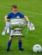 2 July 2019; Seven year old Joe Mallon, a member of the host club, tries to lift the Sam Maguire Cup during the GAA Football All Ireland Senior Championship Series National Launch at Scotstown GAA Club, St Mary's Park, Scotstown, Co. Monaghan. Photo by Ray McManus/Sportsfile