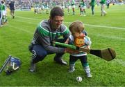 30 June 2019; Limerick supporter Thomas Quaid, age 18 months, with his father Tommy Quaid, Limerick minor hurling selector, at the Munster GAA Hurling Senior Championship Final match between Limerick and Tipperary at LIT Gaelic Grounds in Limerick. Photo by Piaras Ó Mídheach/Sportsfile