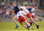 6 July 2019; Patrick Lynch of Cavan breaks the tackles of Conor Quinn, back, and Peadar Mullan, 4, of Tyrone during the EirGrid Ulster GAA Football U20 Championship semi-final match between Cavan and Tyrone at St. Tiernach's Park in Clones, Monaghan. Photo by Ben McShane/Sportsfile