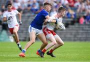 6 July 2019; Sean og McAleer of Tyrone in action against Patrick Meade of Cavan during the EirGrid Ulster GAA Football U20 Championship semi-final match between Cavan and Tyrone at St. Tiernach's Park in Clones, Monaghan. Photo by Oliver McVeigh/Sportsfile