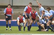 30 October 2003; Ireland scrum half Guy Easterby passes the ball, watched by team-mates, from left, Reggie Corrigan, Malcolm O'Kelly, Simon Easterby, Brian O'Driscoll, Paul O'Connell, Eric Miller, Peter Stringer and Donnacha O'Callaghan during squad training. 2003 Rugby World Cup, Irish squad training, Whitton Oval, Melbourne, Victoria, Australia. Picture credit; Brendan Moran / SPORTSFILE *EDI*