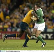 1 November 2003; John kelly, Ireland, is tackled by Australia's Wendell Sailor. 2003 Rugby World Cup, Pool A, Ireland v Australia, Telstra Dome, Melbourne, Victoria, Australia. Picture credit; Ray McManus / SPORTSFILE *EDI*