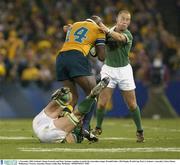1 November 2003; Ireland's Simon Easterby and Peter Stringer combine to tackle the Australian winger Wendell Sailor. 2003 Rugby World Cup, Pool A, Ireland v Australia, Telstra Dome, Melbourne, Victoria, Australia. Picture credit; Ray McManus / SPORTSFILE *EDI*