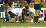 1 November 2003; Denis Hickie, Ireland, is attended to by team physio Ailbe McCormack and doctor Gary O'Driscoll before going off with an injury. 2003 Rugby World Cup, Pool A, Ireland v Australia, Telstra Dome, Melbourne, Victoria, Australia. Picture credit; Brendan Moran / SPORTSFILE *EDI*