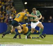 1 November 2003; Denis Hickie, Ireland, is tackled by Australia players Matt Burke, 13, and Wendell Sailor. 2003 Rugby World Cup, Pool A, Ireland v Australia, Telstra Dome, Melbourne, Victoria, Australia. Picture credit; Ray McManus / SPORTSFILE *EDI*