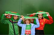 6 July 2019; Mayo supporters, from left, Cian, age 11, Amalie, age 9 and Sofia Corley Clark, age 12, take shelter from the rain ahead of the GAA Football All-Ireland Senior Championship Round 4 match between Galway and Mayo at the LIT Gaelic Grounds in Limerick. Photo by Eóin Noonan/Sportsfile