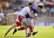 6 July 2019; Dara McVetty of Cavan is tackled by Ronan McNamee, centre, and Rory Brennan of Tyrone during the GAA Football All-Ireland Senior Championship Round 4 match between Cavan and Tyrone at St. Tiernach's Park in Clones, Monaghan. Photo by Ben McShane/Sportsfile