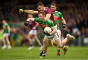 6 July 2019; Colm Boyle of Mayo is tackled by Damien Comer of Galway during the GAA Football All-Ireland Senior Championship Round 4 match between Galway and Mayo at the LIT Gaelic Grounds in Limerick. Photo by Eóin Noonan/Sportsfile