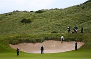18 July 2019; Gary Woodland of USA slips into the bunker after playing a shot on the 7th hole during Day One of the 148th Open Championship at Royal Portrush in Portrush, Co Antrim. Photo by Ramsey Cardy/Sportsfile
