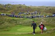 18 July 2019; Brooks Koepka of USA with his caddy Ricky Elliott make their way to the 16th green during Day One of the 148th Open Championship at Royal Portrush in Portrush, Co Antrim. Photo by Ramsey Cardy/Sportsfile